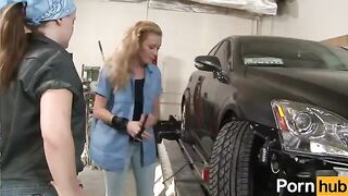 The girl is having fun with her girlfriend in the garage, exploring new things