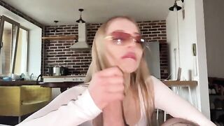 A pretty woman has sex with her boyfriend and gets cum on her glasses