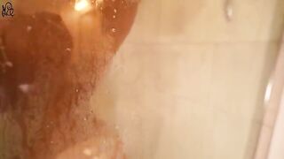 A girl has fun with a huge toy in the shower, creating a wet and wild scene