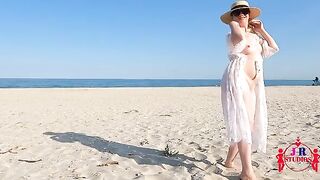 A stunning woman poses naked on the beach for the first time