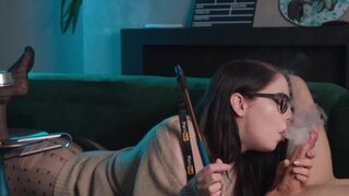 A girl with glasses smokes and sucks cock while being eaten out in 69 position