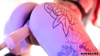 Marseline, a tattooed beauty, indulges in solo play with a toy, showcasing her wild side
