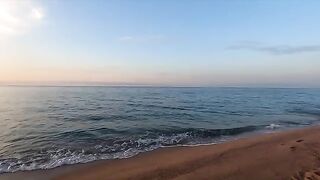A girl is having fun on the beach with a guy she just met