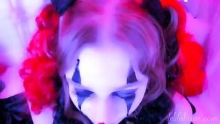 A kinky clown blowjob scene with a facial finish, exploring intense eye contact and costume play