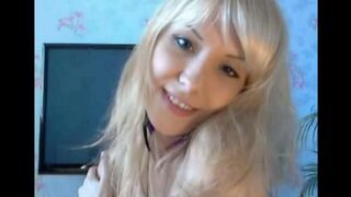 A cute young blonde caresses her pussy with her fingers in a solo scene