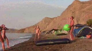 A badminton game with a naked beauty on the beach