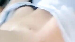 A half-naked girl lies and caresses her body with her hands
