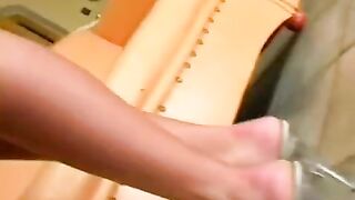 Beautiful woman masturbating herself on a leather chair, showcasing her nice butt