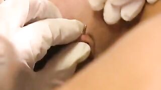 A girl with a nice pussy gets a piercing and plays with toys