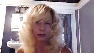 A aged woman caresses herself pleasantly in the bathroom with a vibrator
