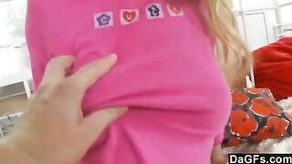 A sweet little girl plays with her pussy using a toy on the bed