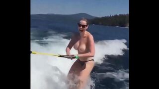Topless girl skiing on water ski