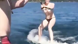 Topless girl skiing on water ski