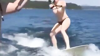 Topless girl skiing on water ski