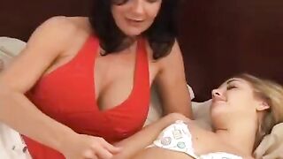 A young girl is having fun with her older girlfriend using a strap-on
