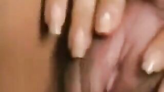A hairy cunt with a large clitoris was played with by a man in this video
