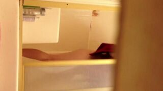 A girl has a shower and is filmed secretly