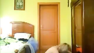 A pervert guy peeps at girls through a camera in their houses