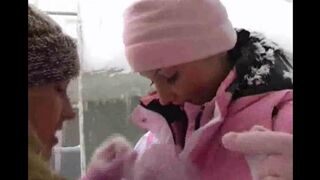 Two girls are having fun while they are indoors on a cold winter day