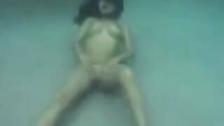 Busty brunette beauty makes love in the ocean, deep in the water