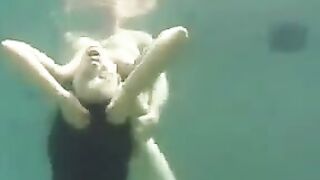 Busty brunette beauty makes love in the ocean, deep in the water