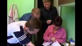 A Russian woman with big tits fucked by four men in the kitchen