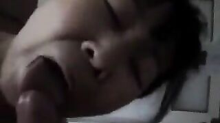 An adult Chinese woman practices her blowjob skills on a man