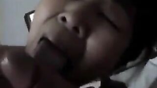 An adult Chinese woman practices her blowjob skills on a man