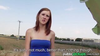A red-haired girl is having fun with someone in the haystack