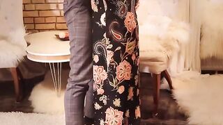 A juicy, redheaded cunt is being fucked in a long black dress and stockings
