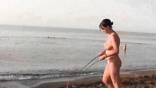 A hot naked girl is having fun on the beach