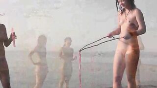 A hot naked girl is having fun on the beach