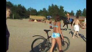 Nude beauties have fun on the beach, showing their bodies to the sun