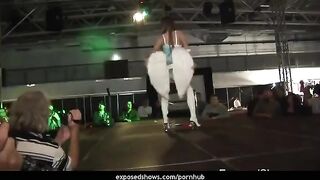 A young girl is learning to striptease on the pole with passion