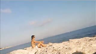A young girl is basking in sunbathing completely naked