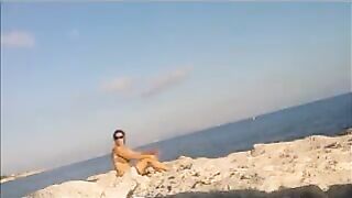 A young girl is basking in sunbathing completely naked