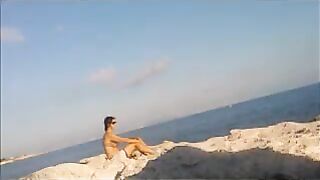 A young girl is basking in sunbathing completely naked
