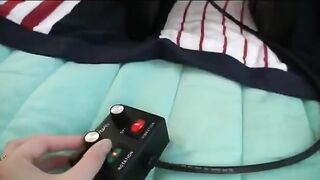 The three girls are having fun with each other using a vibrator