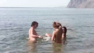 A naked beauty is having fun on the nudist beach