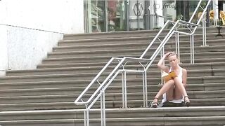 A girl walks outside without panties and a bra, exposing herself in public