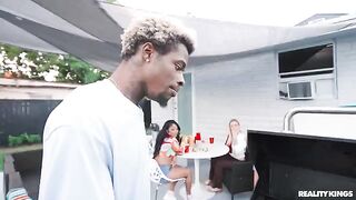 A black guy has fun with a girl at the barbecue