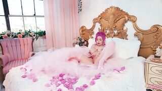 A glamorous woman plays with herself and her big boobs