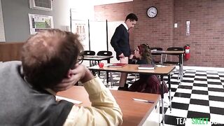 Students are having fun at the table with their teacher in spectacles