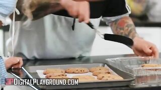 A petite blonde, Khloe Kapri, bakes cookies in a daring apron